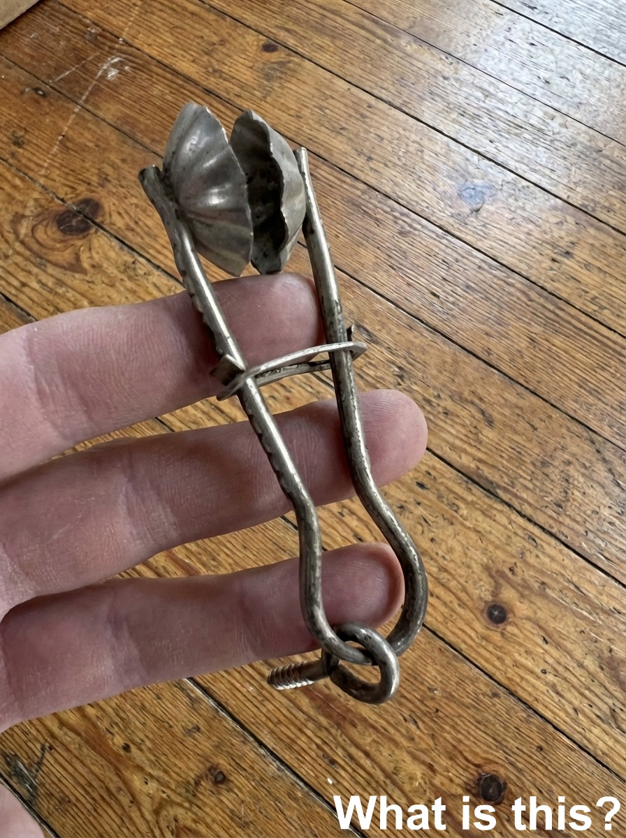 This object was fastened to a wooden post in a warehouse via the eye screw visible in the picture.