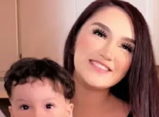 Young woman puts son inside the fir… See more